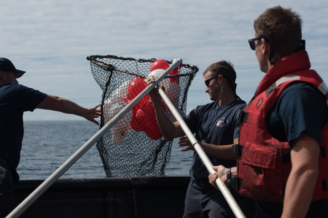 Tully crew removing the balloons from the ocean.